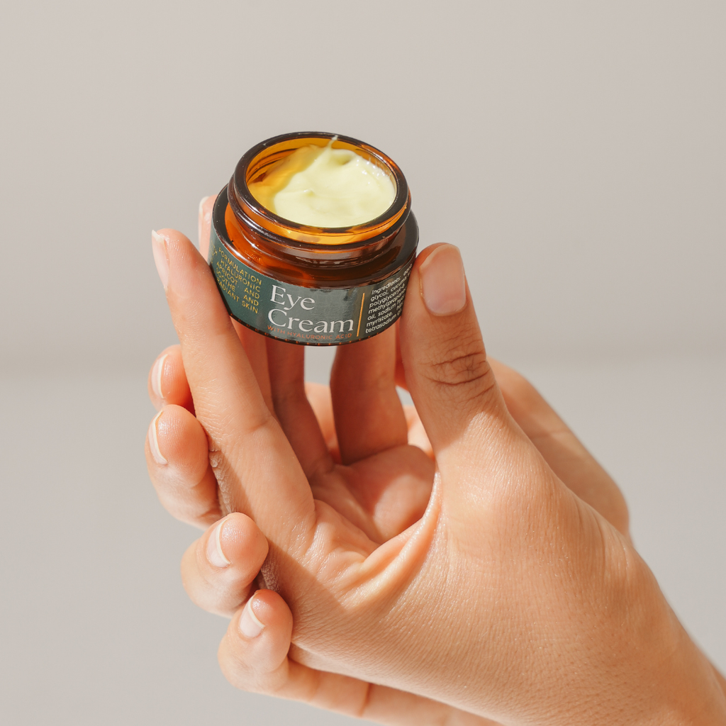 Glass jar of Naturals Beauty botanical eye cream against a neutral background