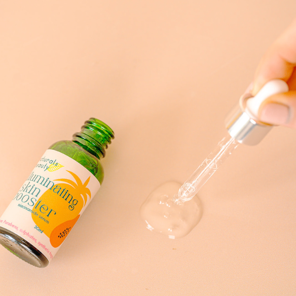 A bottle of Illuminating skin booster serum with an eye dropper