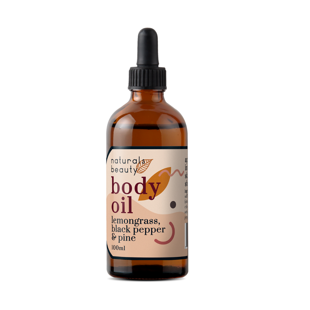Glass bottle of organic body oil with lemongrass, black pepper & pine with a dropper labeled 'naturals beauty' on a white background